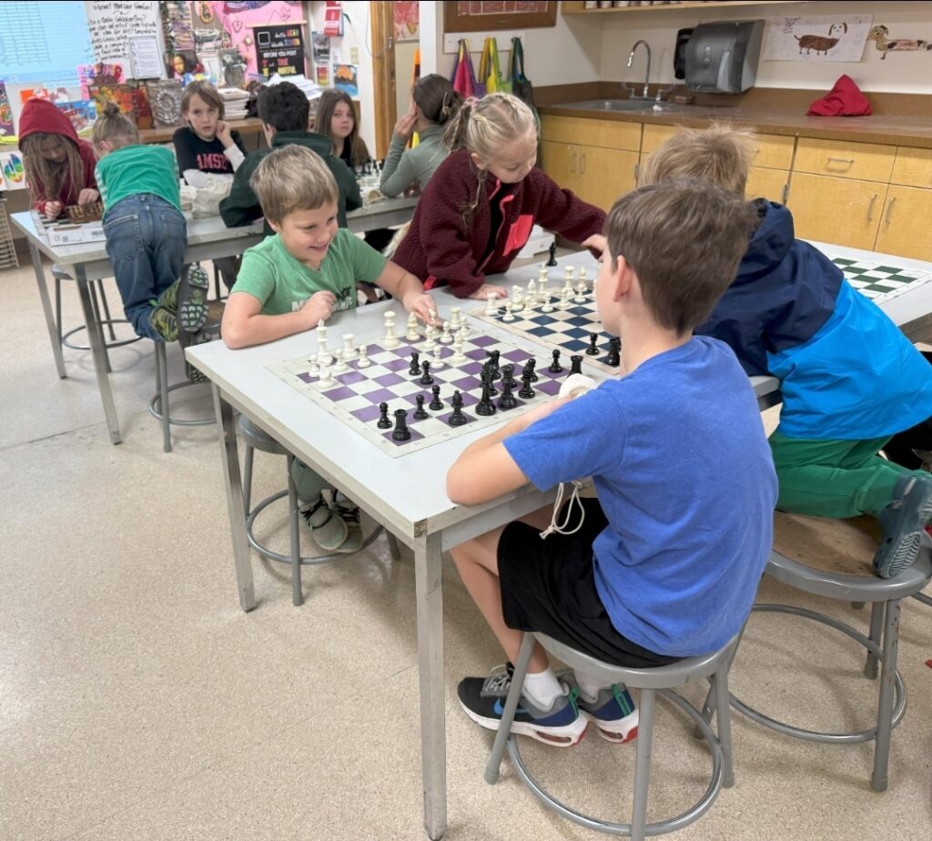 Children playing chess during a classroom lesson at a chess club in Antalya