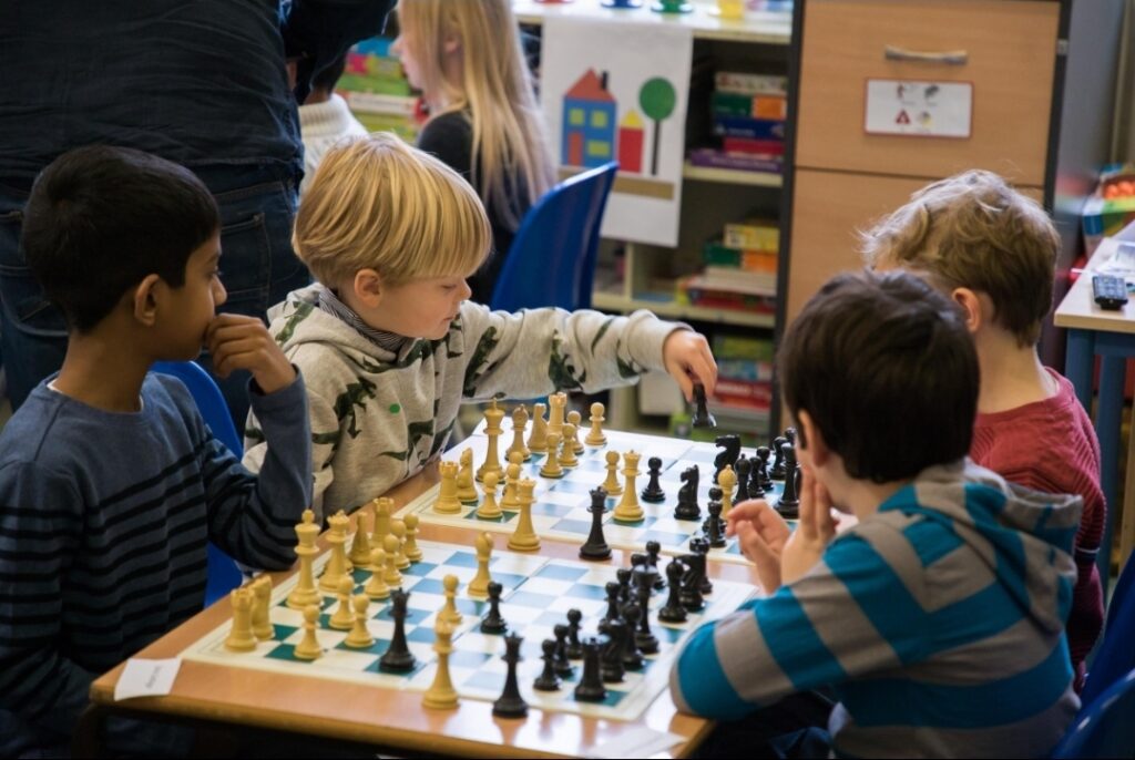 Children learning chess during a group lesson at a chess club in Antalya